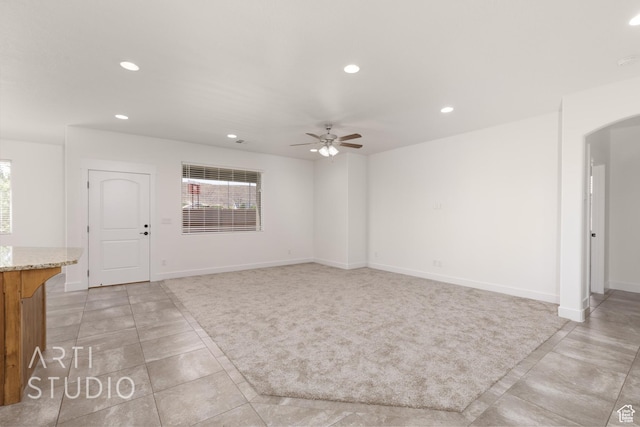 943 N 100 W, Hurricane, UT 84737 - unfurnished living room featuring light tile patterned floors, recessed lighting, a ceiling fan, and arched walkways