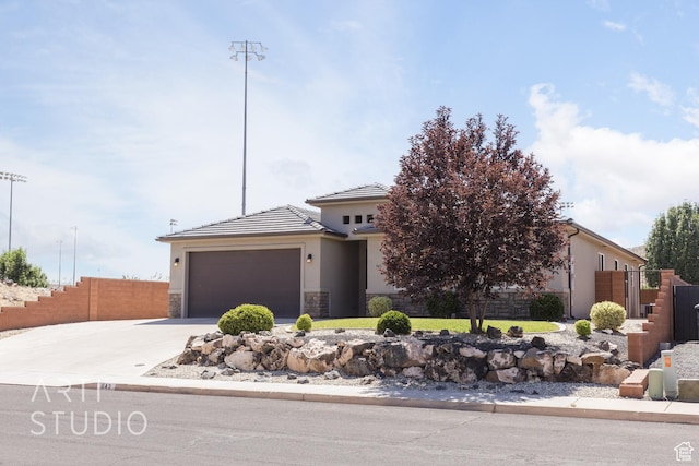 943 N 100 W, Hurricane, UT 84737 - view of front of home with driveway, an attached garage, stucco siding, and stone siding