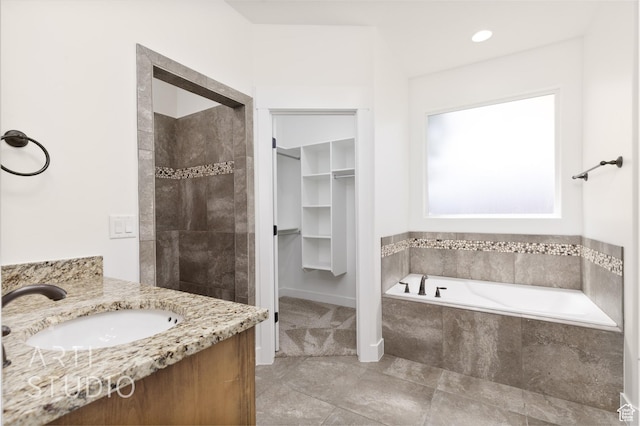 943 N 100 W, Hurricane, UT 84737 - full bath featuring a bath, a walk in closet, vanity, tiled shower, and tile patterned flooring