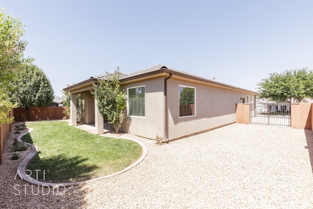943 N 100 W, Hurricane, UT 84737 - view of home's exterior featuring stucco siding, a gate, and gravel driveway