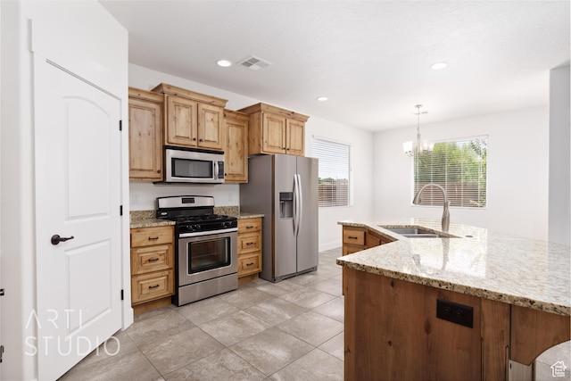 943 N 100 W, Hurricane, UT 84737 - kitchen featuring stainless steel appliances, a chandelier, light stone counters, decorative light fixtures, and recessed lighting