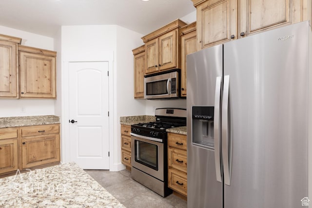 943 N 100 W, Hurricane, UT 84737 - kitchen featuring stainless steel appliances, light stone counters, and light tile patterned floors
