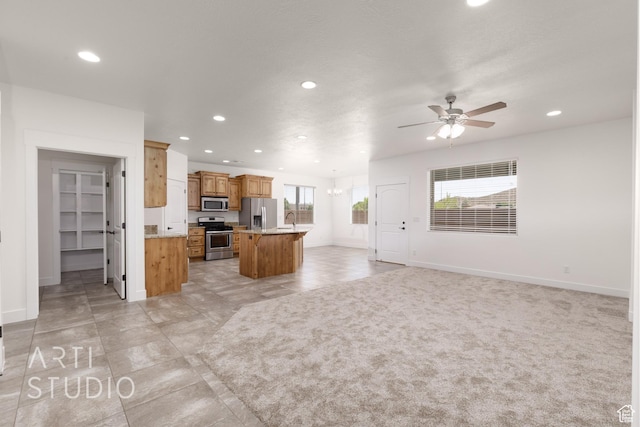 943 N 100 W, Hurricane, UT 84737 - kitchen featuring appliances with stainless steel finishes, recessed lighting, open floor plan, a ceiling fan, and a kitchen island with sink