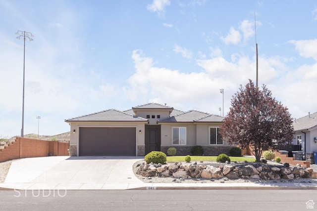 943 N 100 W, Hurricane, UT 84737 - prairie-style house with stone siding, stucco siding, a garage, concrete driveway, and a tile roof