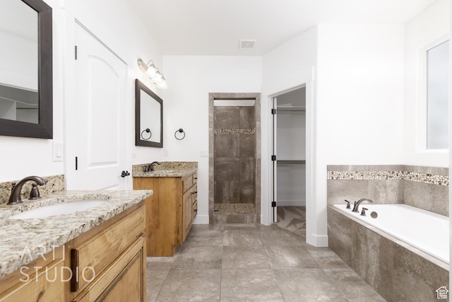 943 N 100 W, Hurricane, UT 84737 - full bath featuring tiled shower, two vanities, a bath, and a walk in closet