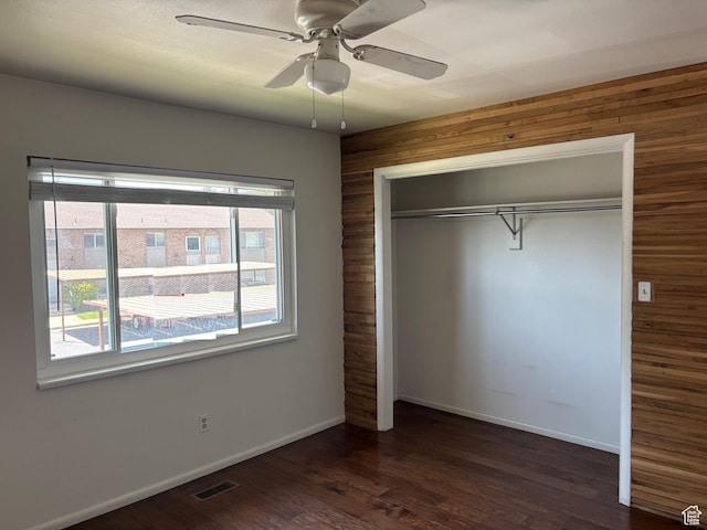 332 W Amiron Way Unit D, Orem, UT 84057 - unfurnished bedroom featuring wood walls, a closet, dark wood finished floors, and a ceiling fan