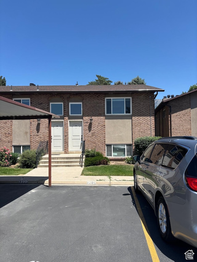 332 W Amiron Way Unit D, Orem, UT 84057 - view of front facade with brick siding, uncovered parking, and entry steps