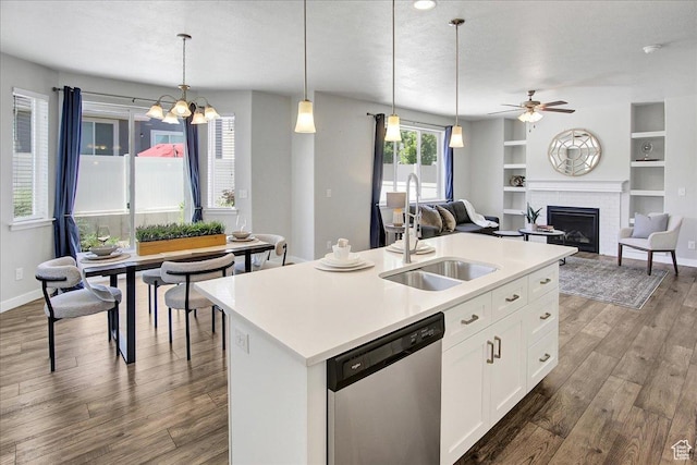 12232 S Sigmon Ln, Herriman, UT 84096 - kitchen with dishwasher, wood finished floors, open floor plan, a fireplace, and ceiling fan