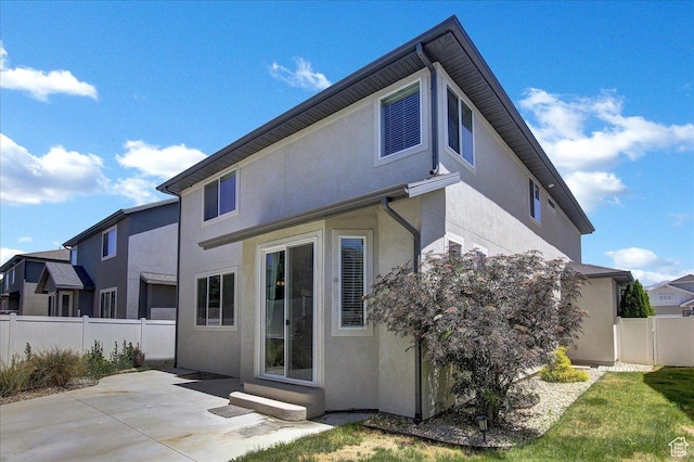 12232 S Sigmon Ln, Herriman, UT 84096 - back of property featuring stucco siding, a patio area, and entry steps