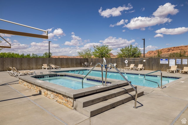 3686 S Spanish Valley Dr Unit Y1, Moab, UT 84532 - community pool featuring a community hot tub and a patio area