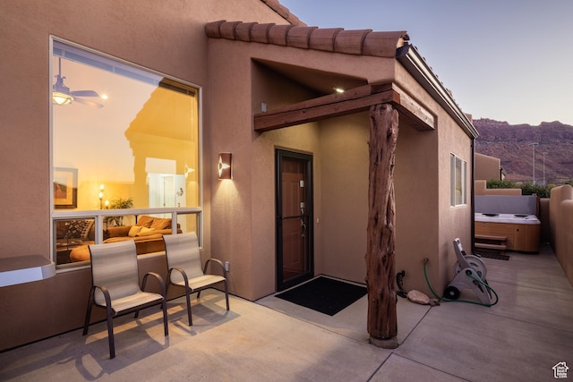 3686 S Spanish Valley Dr Unit Y1, Moab, UT 84532 - property entrance featuring a hot tub, a patio area, a mountain view, and stucco siding