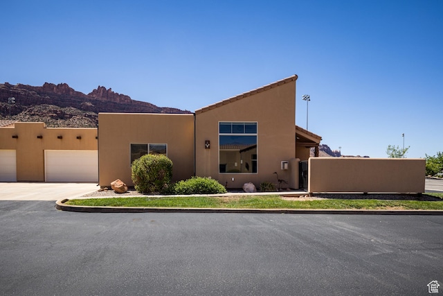 3686 S Spanish Valley Dr Unit Y1, Moab, UT 84532 - southwest-style home featuring a garage, driveway, stucco siding, and a mountain view