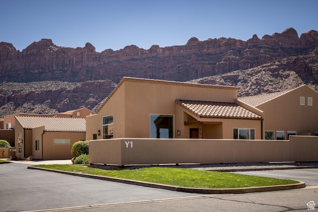 3686 S Spanish Valley Dr Unit Y1, Moab, UT 84532 - view of front of property with a mountain view, stucco siding, a tile roof, and uncovered parking