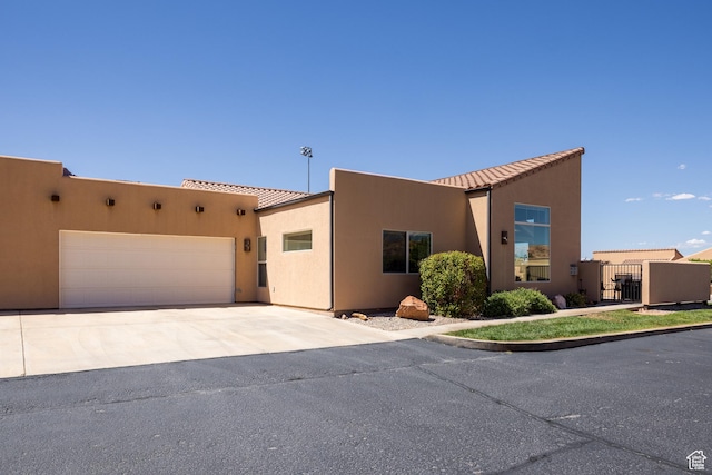 3686 S Spanish Valley Dr Unit Y1, Moab, UT 84532 - adobe home featuring concrete driveway, an attached garage, and stucco siding