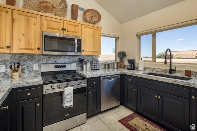3686 S Spanish Valley Dr Unit Y1, Moab, UT 84532 - kitchen with stainless steel appliances, lofted ceiling, light tile patterned flooring, backsplash, and dark cabinetry