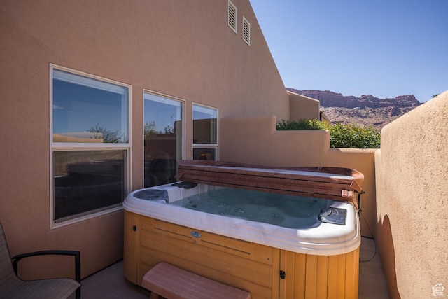 3686 S Spanish Valley Dr Unit Y1, Moab, UT 84532 - view of patio / terrace with a hot tub and a mountain view