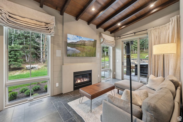 2475 W White Pine Ln Unit 11, Park City, UT 84060 - living room with wood ceiling, a glass covered fireplace, stone tile flooring, and recessed lighting