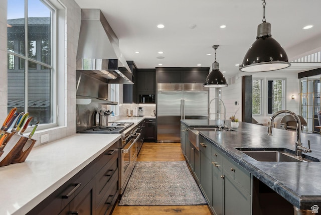 2475 W White Pine Ln Unit 11, Park City, UT 84060 - kitchen with high end appliances, exhaust hood, decorative backsplash, healthy amount of natural light, and recessed lighting