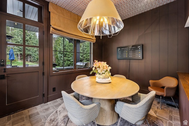 2475 W White Pine Ln Unit 11, Park City, UT 84060 - dining area featuring plenty of natural light, stone finish floors, and wood walls