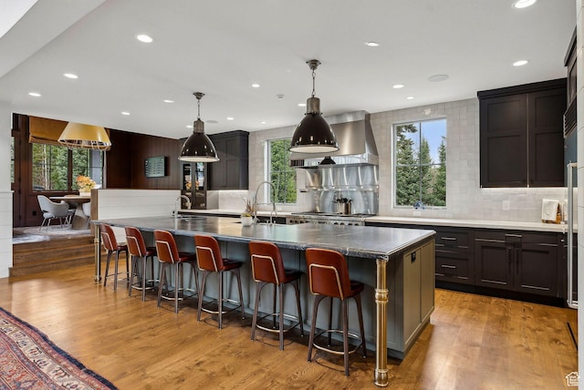 2475 W White Pine Ln Unit 11, Park City, UT 84060 - kitchen with decorative backsplash, exhaust hood, healthy amount of natural light, and recessed lighting