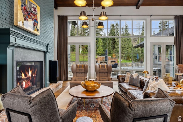 2475 W White Pine Ln Unit 11, Park City, UT 84060 - living area featuring french doors, a high ceiling, healthy amount of natural light, a large fireplace, and beam ceiling