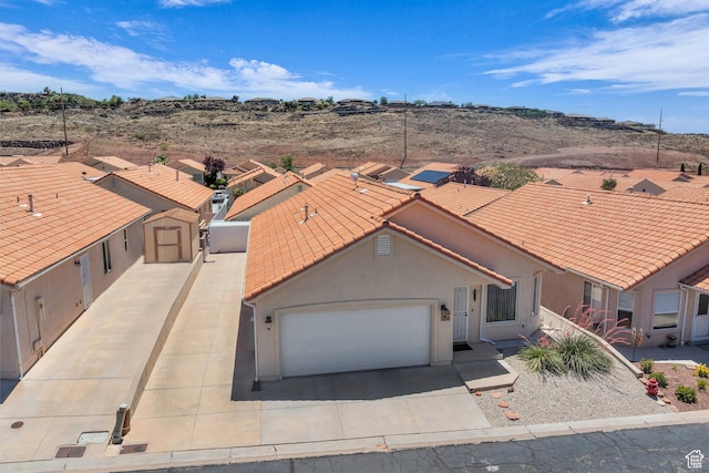 504 E Telegraph St Unit 89, Washington, UT 84780 - view of front of property featuring a tile roof, an attached garage, concrete driveway, and stucco siding