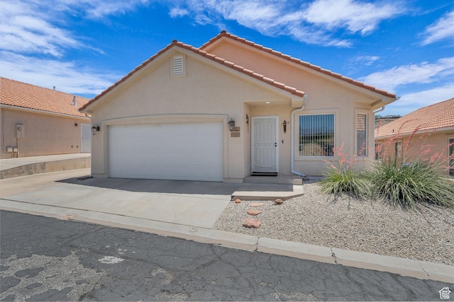 504 E Telegraph St Unit 89, Washington, UT 84780 - mediterranean / spanish home featuring an attached garage, stucco siding, driveway, and a tiled roof