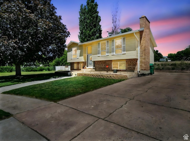 2802 W 4875 S, Roy, UT 84067 - bi-level home with a lawn, a chimney, and brick siding