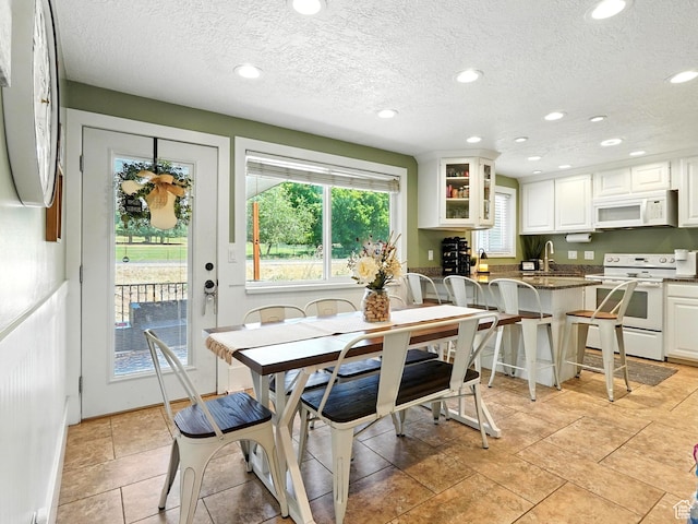2802 W 4875 S, Roy, UT 84067 - dining room featuring recessed lighting, a textured ceiling, and light tile patterned flooring