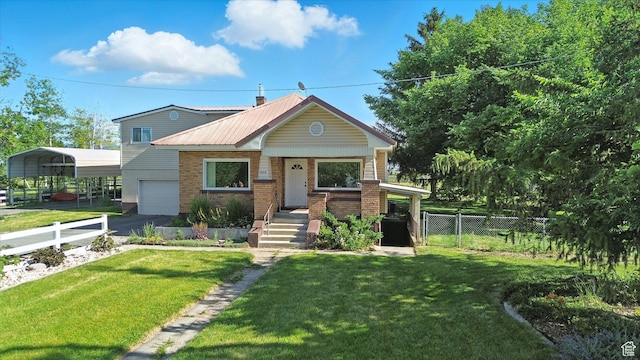 3074 W 3200 N, Benson, UT 84335 - view of front facade with a garage, asphalt driveway, brick siding, a metal roof, and a porch