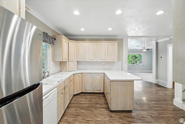3074 W 3200 N, Benson, UT 84335 - kitchen with freestanding refrigerator, light brown cabinetry, white dishwasher, a peninsula, and crown molding