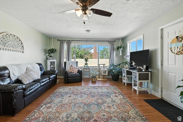 3074 W 3200 N, Benson, UT 84335 - living room with plenty of natural light, a ceiling fan, a textured ceiling, and wood finished floors