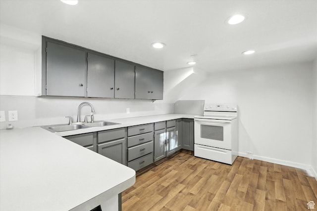 3074 W 3200 N, Benson, UT 84335 - kitchen featuring white range with electric stovetop, gray cabinetry, light wood-style floors, light countertops, and recessed lighting
