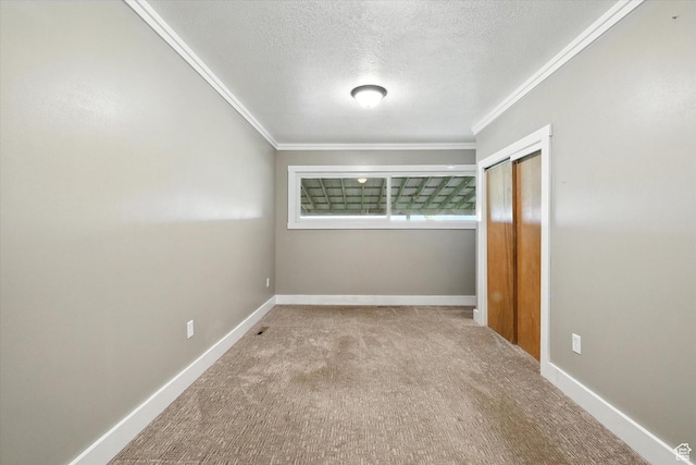 3074 W 3200 N, Benson, UT 84335 - unfurnished bedroom with crown molding, a textured ceiling, a closet, and carpet