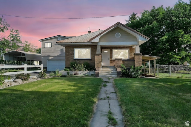 3074 W 3200 N, Benson, UT 84335 - view of front of house with brick siding, a garage, a gate, a carport, and a metal roof