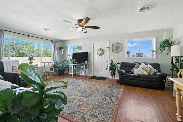 3074 W 3200 N, Benson, UT 84335 - living area featuring ceiling fan, wood finished floors, and a textured ceiling
