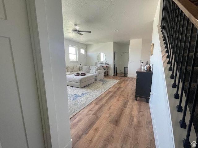 225 W 400 S, Ephraim, UT 84627 - living room with a ceiling fan, wood finished floors, stairway, and a textured ceiling
