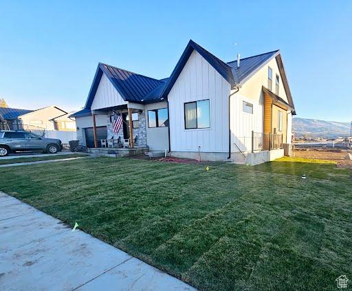 225 W 400 S, Ephraim, UT 84627 - view of front of property with board and batten siding, a front yard, and a metal roof