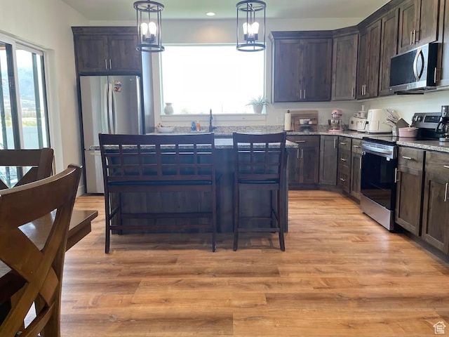 225 W 400 S, Ephraim, UT 84627 - kitchen featuring appliances with stainless steel finishes, dark brown cabinetry, and light wood finished floors