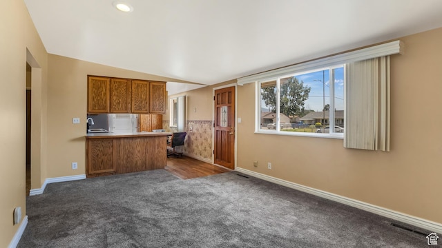 1254 Marilyn Dr, Layton, UT 84041 - kitchen with dark carpet, brown cabinetry, a peninsula, and open floor plan