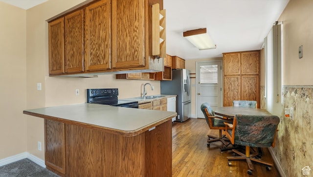 1254 Marilyn Dr, Layton, UT 84041 - kitchen with black electric range, stainless steel fridge with ice dispenser, brown cabinets, and a peninsula