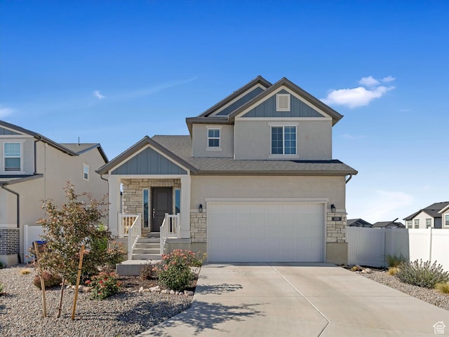 406 W Tesla Ct, Grantsville, UT 84029 - view of front of house with stone siding, concrete driveway, a garage, roof with shingles, and stucco siding