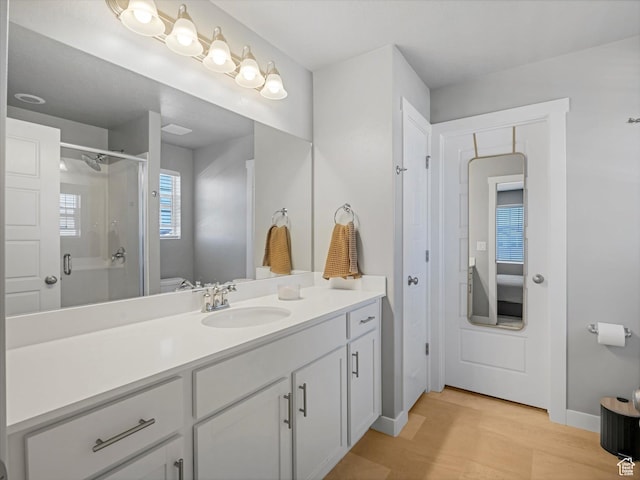 406 W Tesla Ct, Grantsville, UT 84029 - full bath with vanity, a shower stall, wood finished floors, and connected bathroom