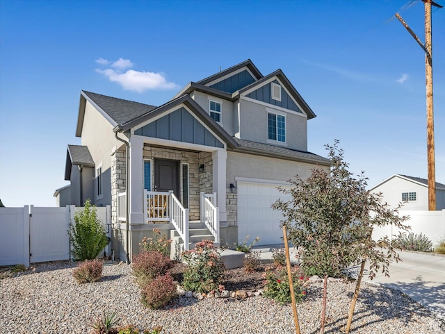 406 W Tesla Ct, Grantsville, UT 84029 - view of front of house with stone siding, a garage, concrete driveway, board and batten siding, and roof with shingles