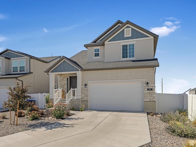 406 W Tesla Ct, Grantsville, UT 84029 - view of front of property with stone siding, driveway, an attached garage, and board and batten siding