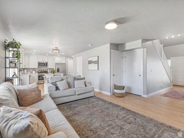 406 W Tesla Ct, Grantsville, UT 84029 - living area featuring light wood-type flooring and a textured ceiling