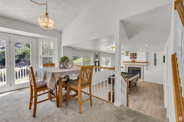 1156 E Avalon Hills Dr N, Ogden, UT 84404 - dining space featuring vaulted ceiling, a chandelier, and a glass covered fireplace