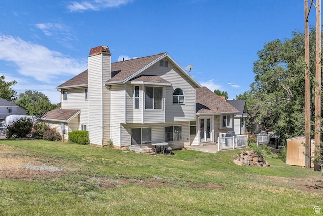 1156 E Avalon Hills Dr N, Ogden, UT 84404 - rear view of property with a storage shed, roof with shingles, a yard, and a chimney