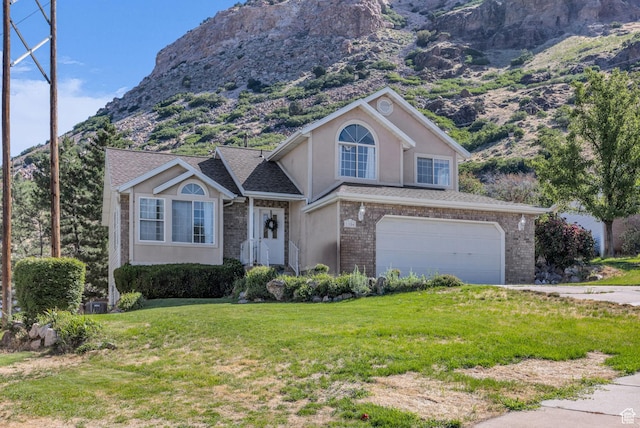 1156 E Avalon Hills Dr N, Ogden, UT 84404 - view of front of property with a garage, a front yard, a mountain view, concrete driveway, and stucco siding