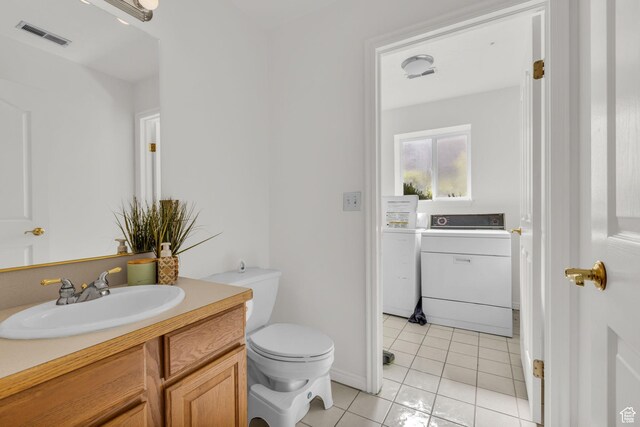 1156 E Avalon Hills Dr N, Ogden, UT 84404 - half bathroom with washer / dryer, vanity, and tile patterned flooring